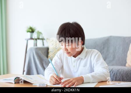 Japanese kid studying at home Stock Photo