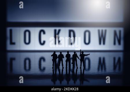 Lockdown concept images - Low key miniature toy figures of security forces - silhouette of army or police forces. Stock Photo