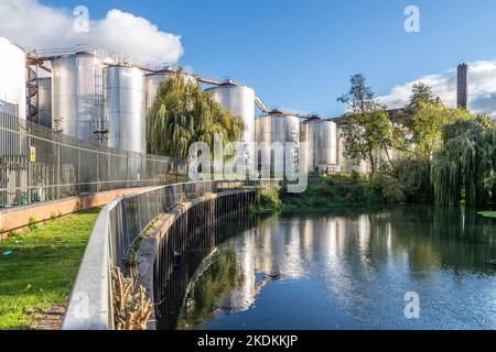 Storage vats at the rear of Carlsberg brewery taken from a public footpath, Northampton, England, UK. Stock Photo