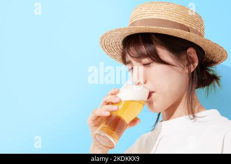 Young Japanese woman drinking beer Stock Photo