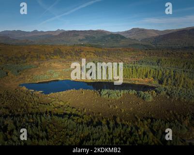 Aerial view of Lochan Reòidhte and the Duke's Pass in the Trossachs on a beautiful autumn day. Stock Photo
