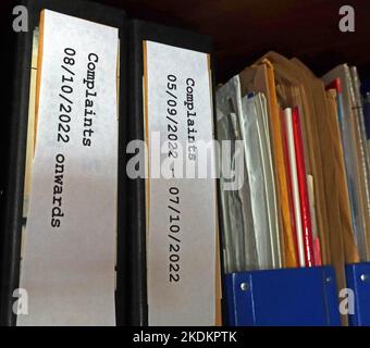 Two fat complaint lever arch files, bulging and only covering a month, in an office Stock Photo
