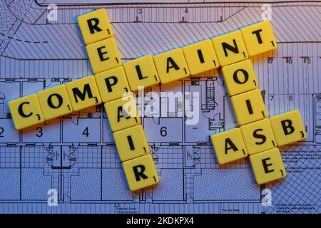 Scrabble letters on plans for a housing scheme - Property Issues Stock Photo