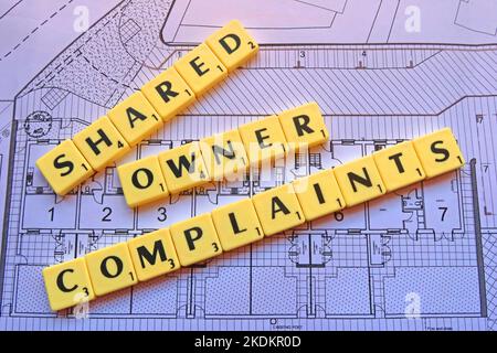 Shared Owner Complaints - Scrabble letters on plans for a housing scheme - Property Issues Stock Photo