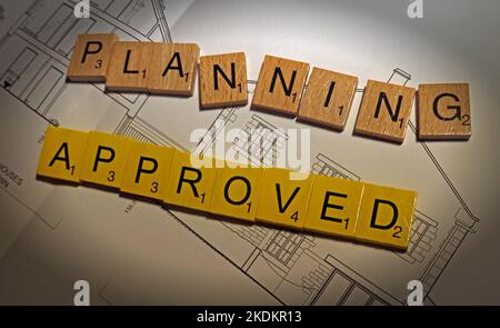 Planning Approved for new development - Scrabble letters on plans for a housing scheme - Property Issues Stock Photo