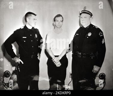 Lee Harvey Oswald and two policemen - taken after Oswald's arrest 1963 Stock Photo