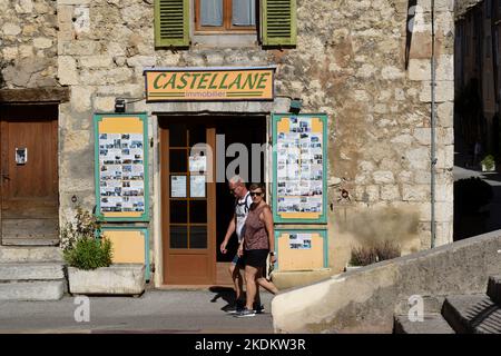 Middle-Aged Couple Window Shopping in Estate Agent, Estate Agency, Real Estate Agent, Property Brocker or Real Estate Broker Provence France Stock Photo
