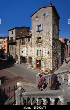 A Couple of Tourists Explore or Wander in a Town Square of the Old Town or Historic District of Castellane Alpes-de-Haute-Provence Provence France Stock Photo