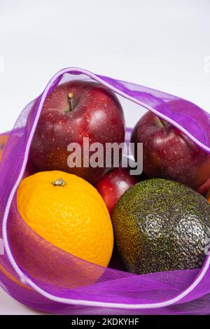 Fabric mesh for fruits and vegetables on a white background. A reusable alternative to plastic bags. Stock Photo