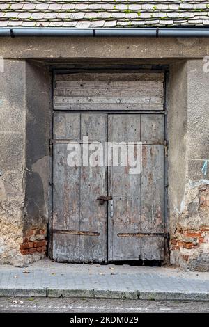 Old grunge wooden door with antique rusty padlock Stock Photo
