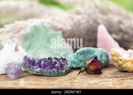 Crystal Healing Stones with Blurred Background and Focus on the Purple Amethyst. Gemstones for Esoteric Spiritual Practice or Witchcraft Set Up on Woo Stock Photo