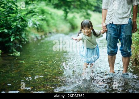 Japanese kid with her father at city park Stock Photo