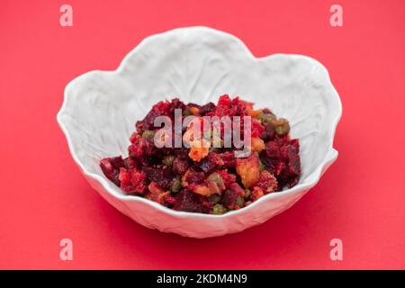Beetroot and boiled vegetables, traditional Russian homemade salad in white bowl. Stock Photo