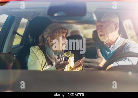 Senior couple using gps on their mobile phone during a road trip Stock Photo