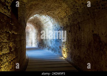 Narrow Tunnel with Sunbeams from small windows Stock Photo