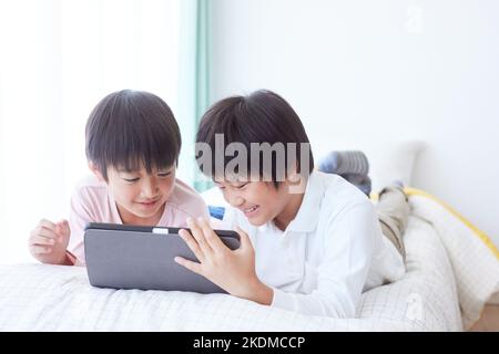Japanese kids using tablet Stock Photo