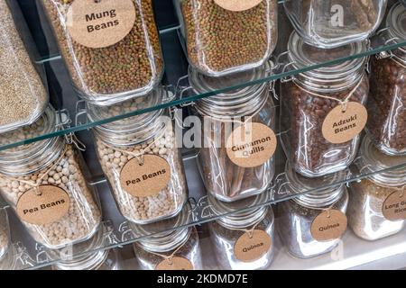 Health Foods Food Ingredients, Detox, Mung, Pea Beans, Cinnamon Quills, Adzuki beans in healthfood store situation in glass storage jars on display. Stock Photo