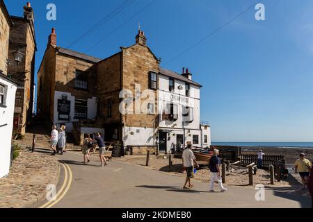 Robin Hood's Bay, UK: The Bay Hotel on King Street, overlooking the dock entrance from the North Sea Stock Photo