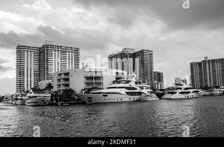 Aventura, Miami, Florida, USA - November 6, 2022: Aventura Landscape in black and white from Waterway with skyrisers, water channel, boats and skies Stock Photo