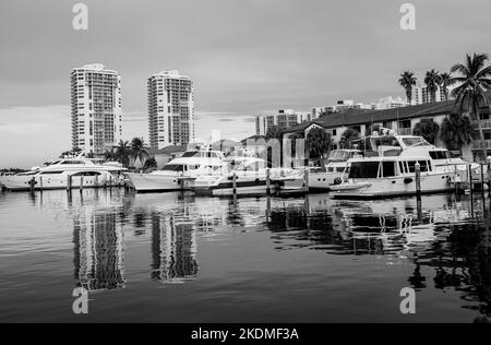 Aventura, Miami, Florida, USA - November 6, 2022: Aventura Landscape in black and white from Waterway with skyrisers, water channel, boats and skies Stock Photo