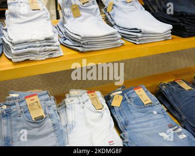Clothes Folded on Table in Retail Store Stock Photo