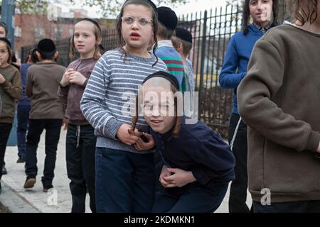 Orthodox jewish boys play during recess outside a yeshiva in Brooklyn, New York. Stock Photo