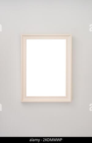 Beige empty photo frame hanging on the wall Stock Photo