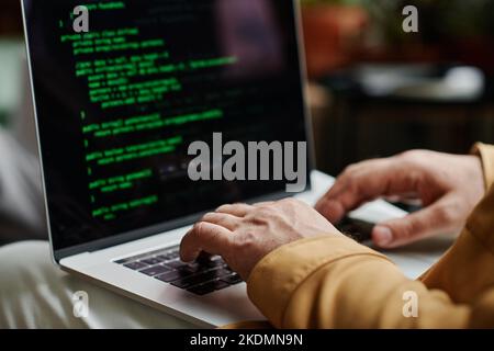 Hands of modern programmer or software developer typing on laptop keyboard while decoding data or working over new IT project Stock Photo