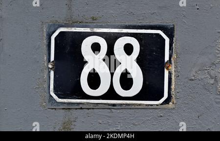 Street sign number 88 on a gray wall Stock Photo