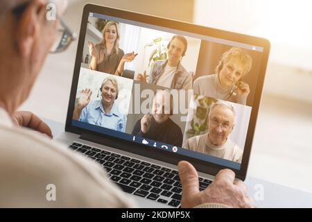 Man Working From Home Having Online Group Videoconference On Laptop. Stock Photo