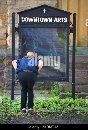 A man scrutinizing an empty  downtown arts sign on North Franklin Street in downtown Wilkes Barre, Pennsylvania. Stock Photo