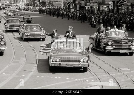President John F. Kennedy with King Hassan II of Morocco standing in a car, during the welcoming parade for Hassan's visit to Washington, D.C.C Stock Photo