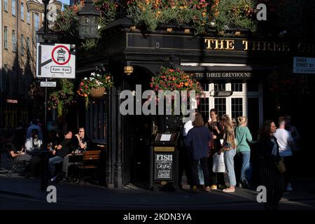 Afternoon drinkers, enjoying the sunshine outside, The Three Greyhounds Pub, 25 Greek Street, Soho, London, UK.  14 Sep 2022 Stock Photo