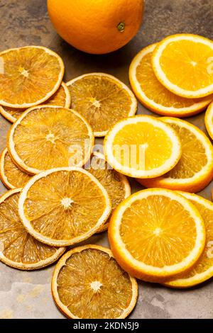 Dry orange slices and fresh orange slices on rusty metal background. Flat lay. Stock Photo