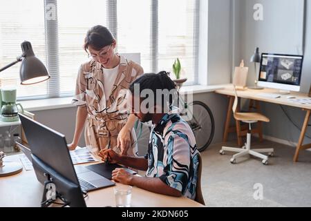 Portrait of two creative designers collaborating on project together in office setting, copy space Stock Photo
