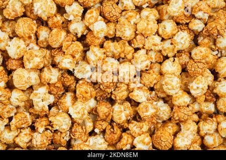 Popcorn background. Sweet caramel popcorn closeup, top view. Stock Photo