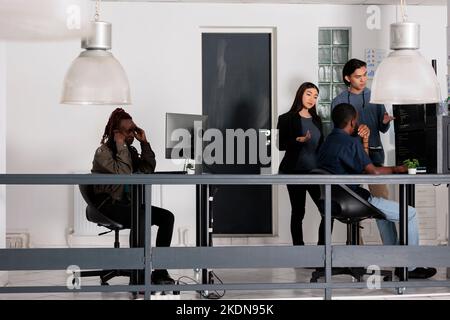 African american web developer brainstorming ideas for html script development, trying to create html code. It software developer working at database server in software office company Stock Photo