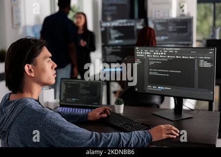 It engineer working on new user interface with online system to create algorithm in agency office. App developer programming html code algorithm on computer, typing sever data Stock Photo