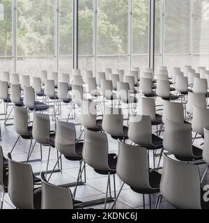 Interior of empty contemporary conference hall with white chairs Stock ...