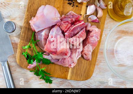 Raw sliced rabbit lying on wooden cutting board with seasonings Stock ...