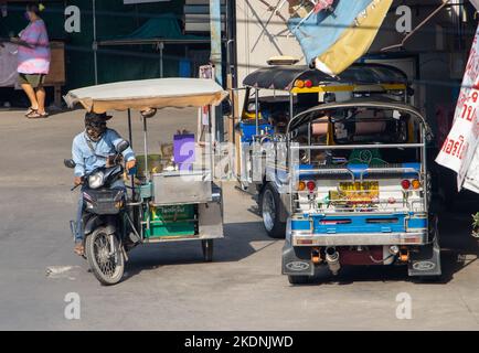 SAMUT PRAKAN, THAILAND, OCT 20 2022, An ice cream man with a mobile shop on a motorbike depart from a tricycle taxi station Stock Photo