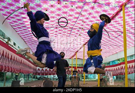 Mumbai, India. 07th Nov, 2022. Nihangs or Sikh warriors perform Gatka (form of martial art) ahead of the birthday celebration of Guru Nanak Dev Ji in Mumbai. Gatka is a Punjabi word that translates to wooden sticks, which are used instead of swords. it uses a sword as the main weapon, amongst others. person's spiritual and physical aspect is developed during the learning phase of this ancient art. Gatka was extensively used by Sikh warriors to defend themselves from the atrocities of the Mughals and the British rulers. Credit: SOPA Images Limited/Alamy Live News Stock Photo