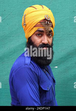 Mumbai, India. 07th Nov, 2022. Nihang or Sikh warrior poses for a photo ahead of the birthday celebration of Guru Nanak Dev Ji in Mumbai. Gatka is a Punjabi word that translates to wooden sticks, which are used instead of swords. it uses a sword as the main weapon, amongst others. person's spiritual and physical aspect is developed during the learning phase of this ancient art. Gatka was extensively used by Sikh warriors to defend themselves from the atrocities of the Mughals and the British rulers. Credit: SOPA Images Limited/Alamy Live News Stock Photo