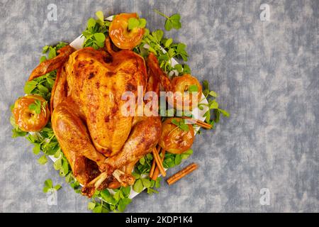 A golden roasted turkey garnished with apples and caramel sauce. Stock Photo