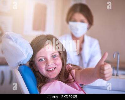 Ready for her first dental examination. a little girl at the dentist for a checkup. Stock Photo
