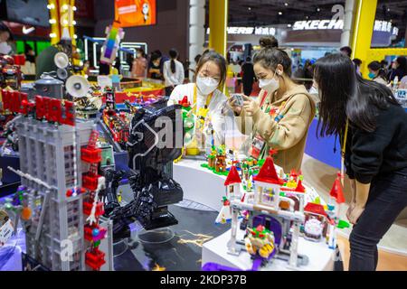 SHANGHAI, CHINA - NOVEMBER 7, 2022 - Visitors experience Lego toys at the booth of the Consumer Goods section of the Fifth International Import Expo ( Stock Photo