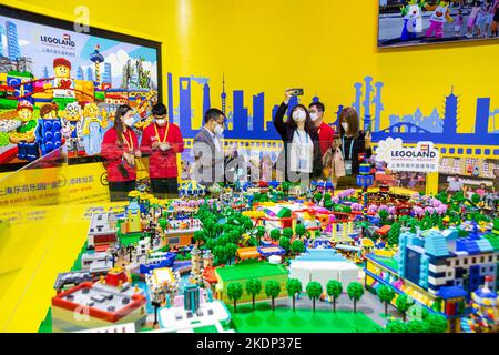 SHANGHAI, CHINA - NOVEMBER 7, 2022 - Visitors experience Lego toys at the booth of the Consumer Goods section of the Fifth International Import Expo ( Stock Photo