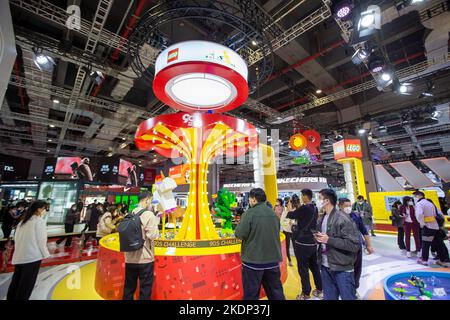 SHANGHAI, CHINA - NOVEMBER 7, 2022 - Visitors experience Lego toys at the booth of the Consumer Goods section of the Fifth International Import Expo ( Stock Photo