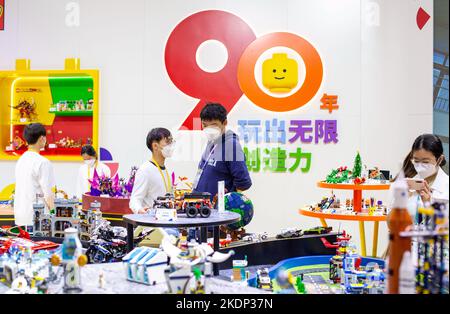 SHANGHAI, CHINA - NOVEMBER 7, 2022 - Visitors experience Lego toys at the booth of the Consumer Goods section of the Fifth International Import Expo ( Stock Photo