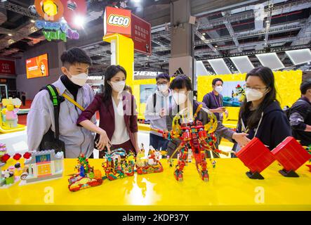 SHANGHAI, CHINA - NOVEMBER 7, 2022 - Visitors experience Lego toys at the booth of the Consumer Goods section of the Fifth International Import Expo ( Stock Photo